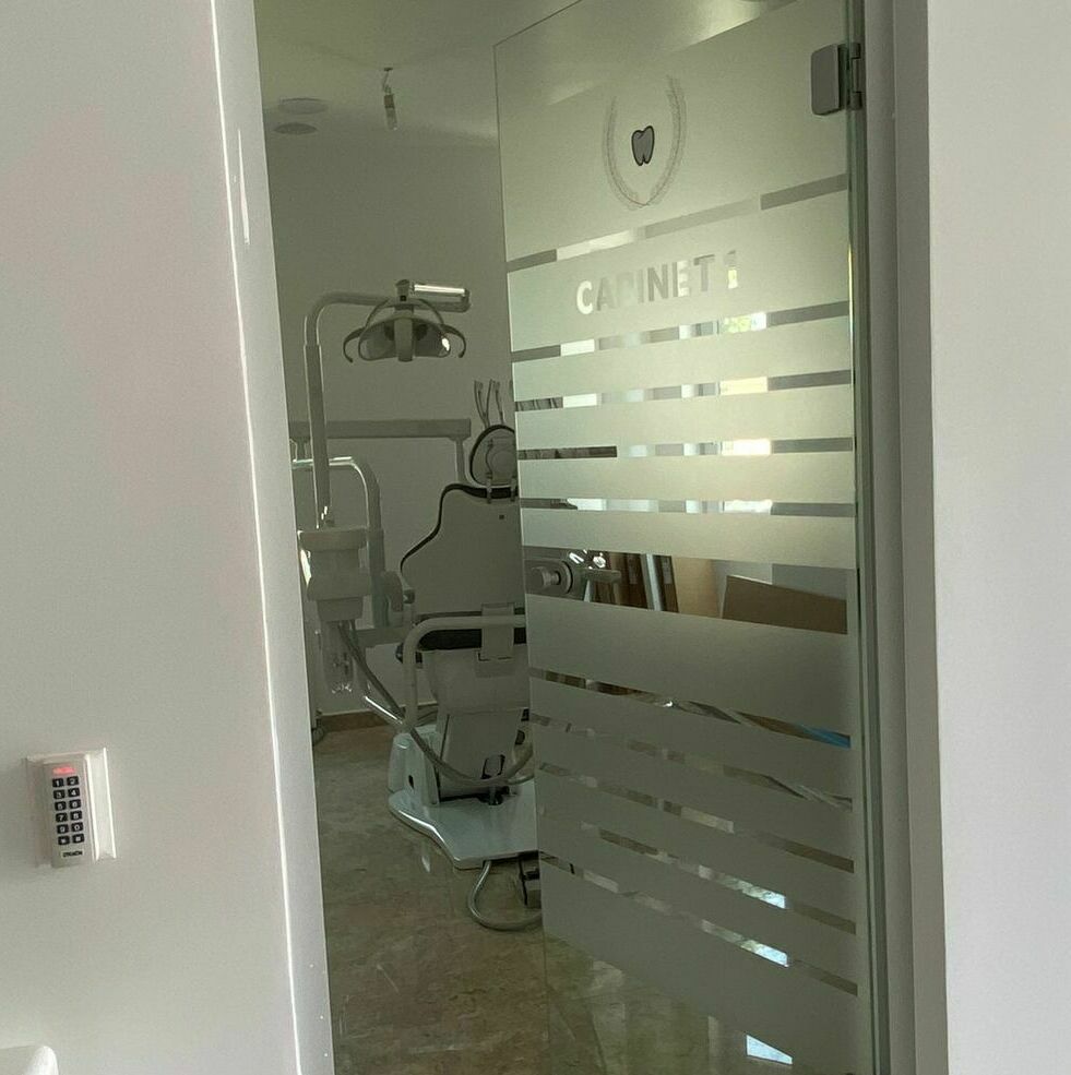 Decor geam cu folie sablată pentru cabinet stomatologic Sibiu Aplicare folie sablată pentru decorarea geamului în cel mai mare cabinet stomatologic din Sibiu, design interior personalizat și elegant.
